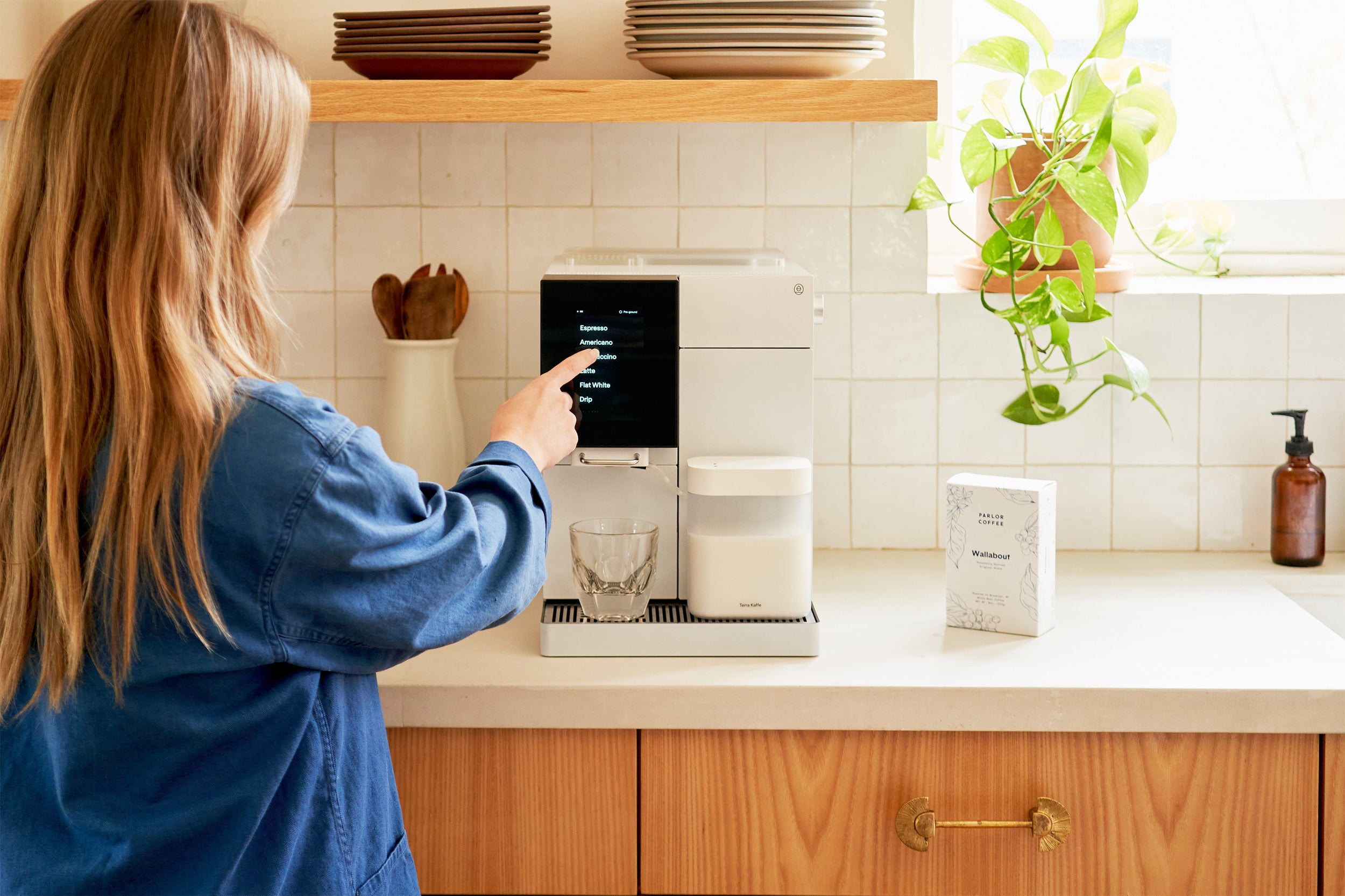 Female touching a white TK-02 on a kitchen counter